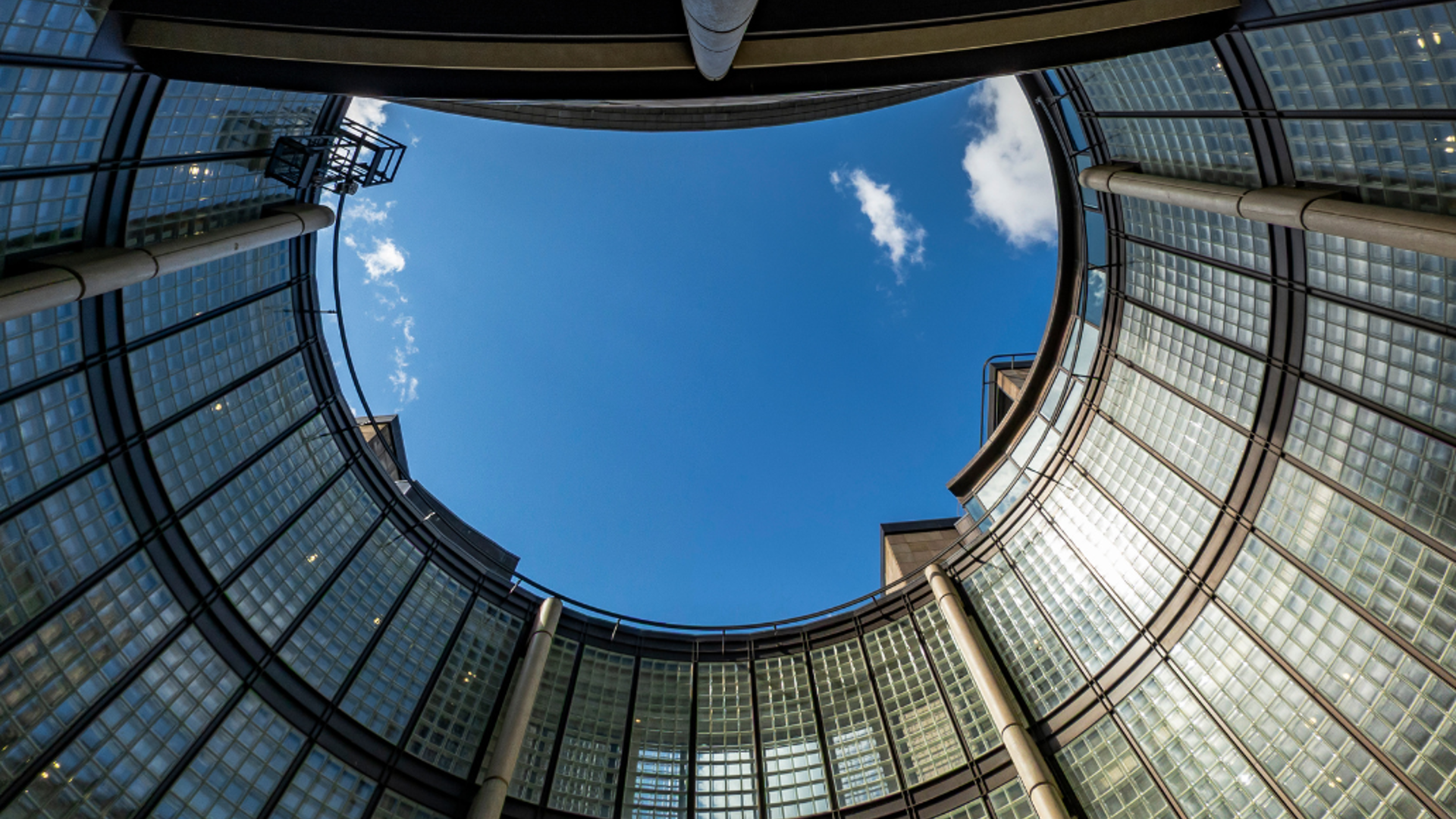 View from inside a circular court yerd at the centre of a high rise commercial building.